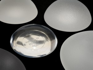 silicone breast implants micro textured and smooth surface isolated on black background