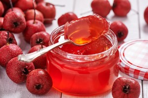 Jar with teaspoon jelly hawthorn surrounded raw berries hawthorn