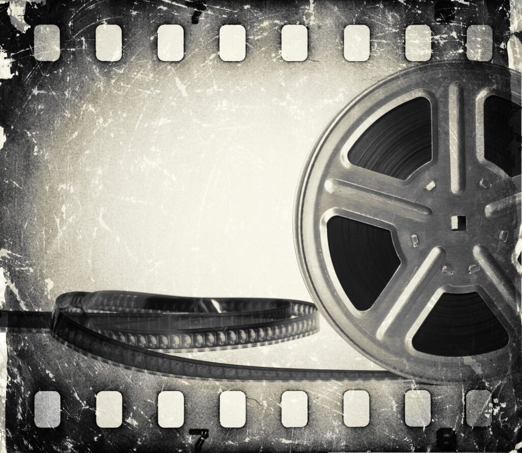 grunge old motion picture film reel with film strip.