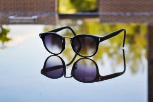 sunglasses reflection on table - fashion accessories